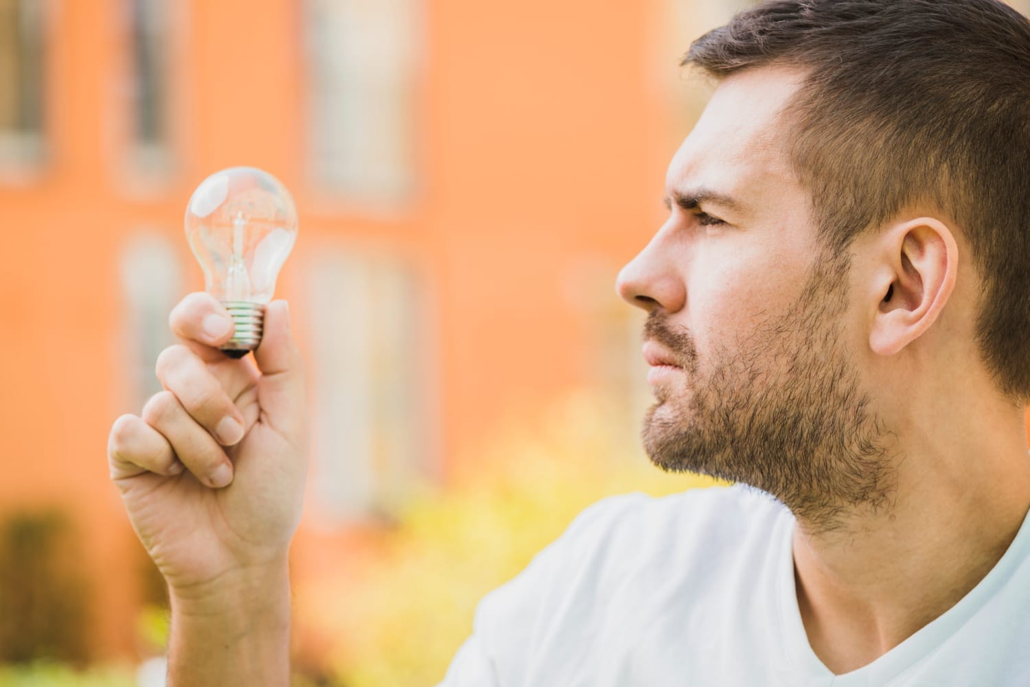 a man staring at a 365nm LED light bulb